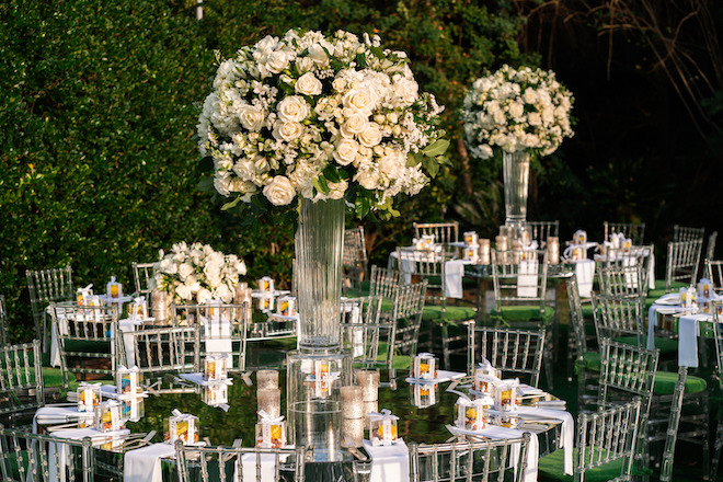 Grand centerpieces with greenery and white roses.