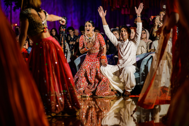 The bride and groom cheering at their Mehndi.