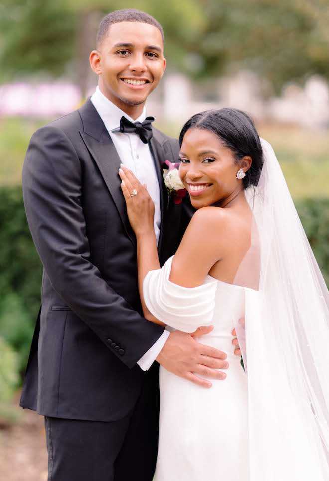 The bride and groom smiling for the camera.