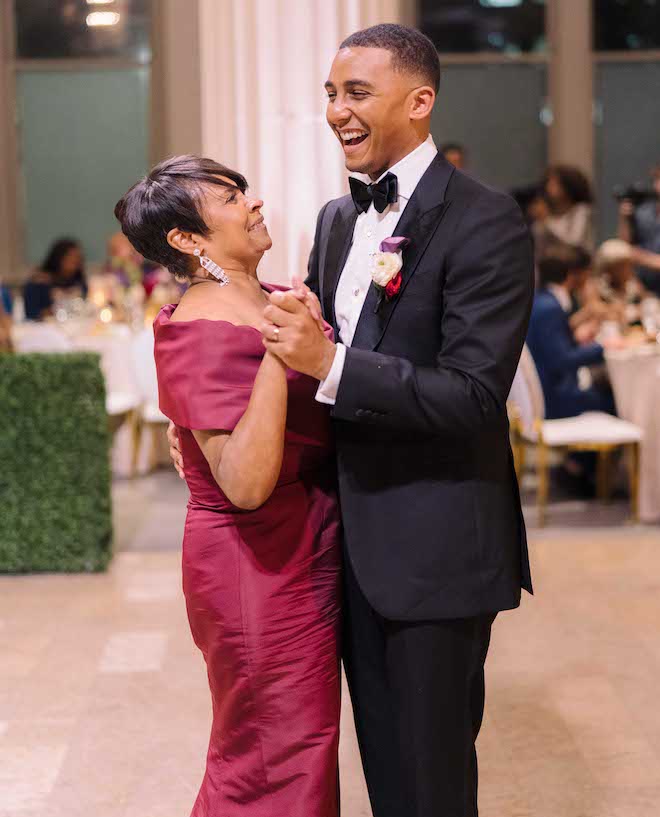 The groom and his mother laughing as they dance.