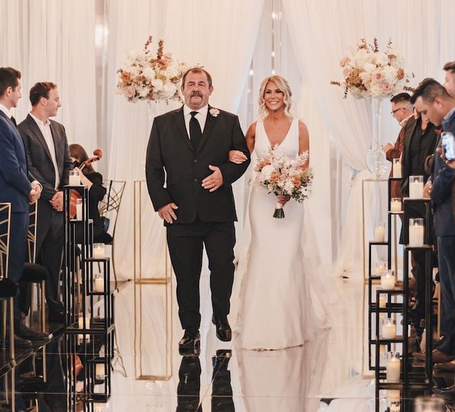 The bride and her father walking down the aisle.