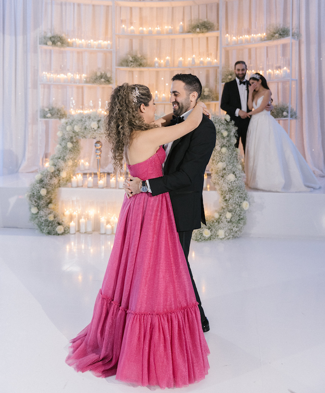 The maid of honor and her husband dancing during a wedding reception at Omni Houston Hotel. 