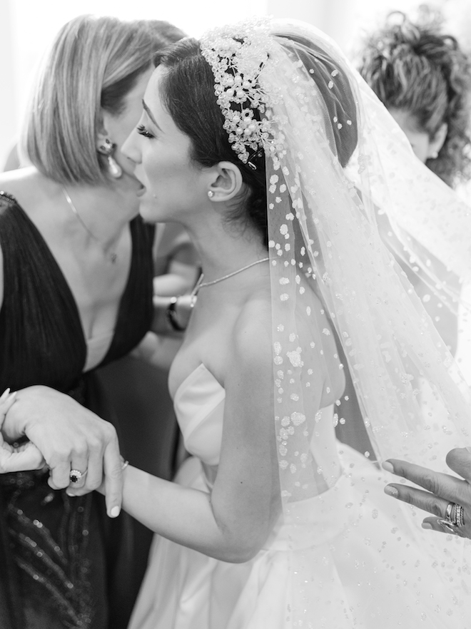 The bride hugging a woman before her wedding.