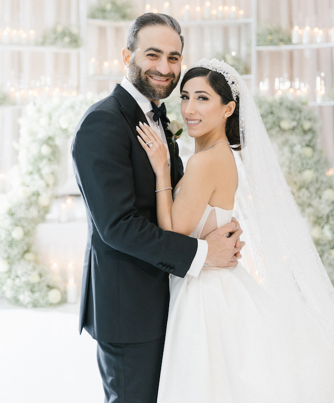 The bride and groom smiling at their reception at Omni Houston Hotel.