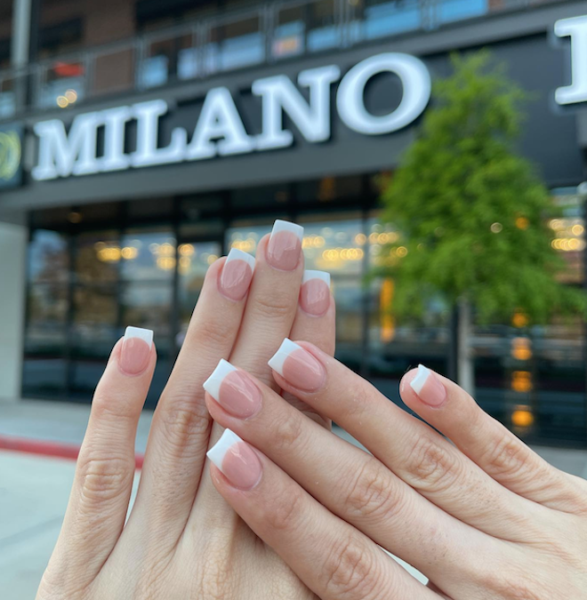 French manicure set on a hand outside of Milano Nail Spa in the Houston Heights