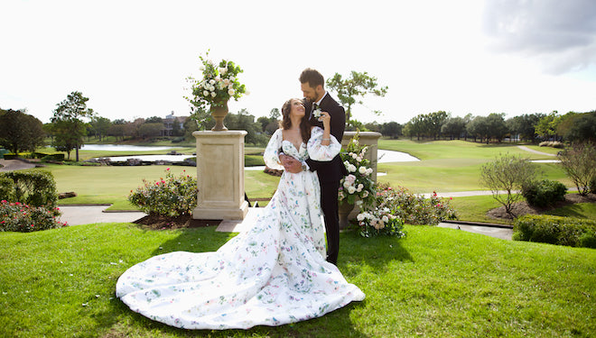 The bride looking back at the groom as they smile at their whimsical ceremony at Royal Oaks Country Club.