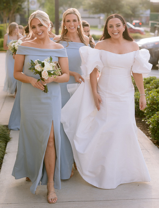 The bride and her bridesmaids walking before the spring wedding.