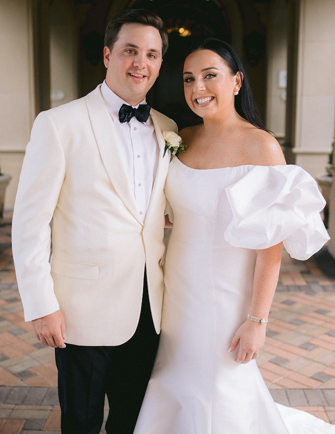 The bride and groom smiling at Royal Oaks Country Club on their wedding day.