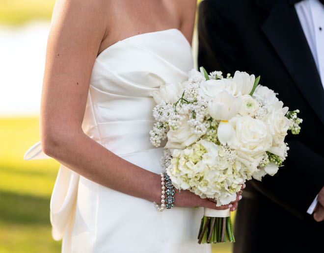 The brides bracelets and a white bouquet.