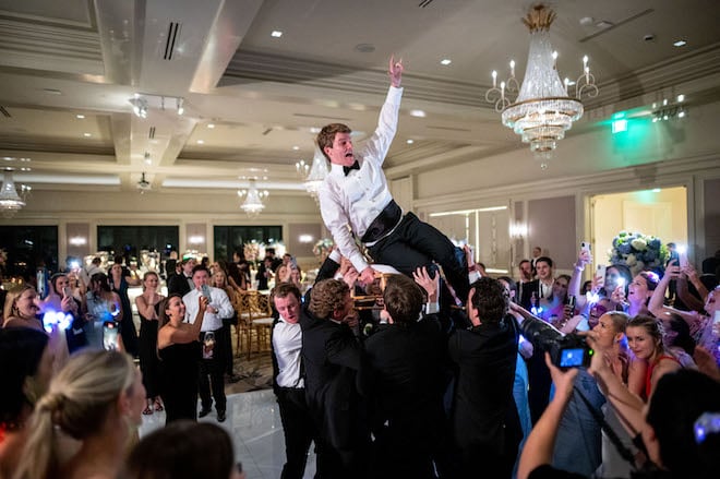 The groom crowd surfing during their wedding reception.