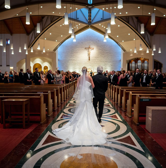 The bride and her father walking down the aisle.