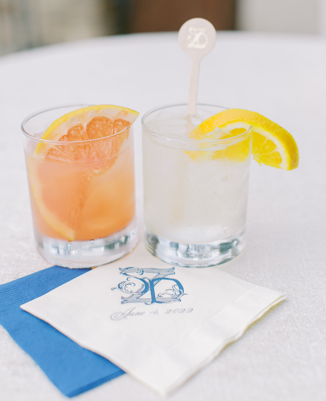 Two cocktails with blue and white monogrammed napkins. 