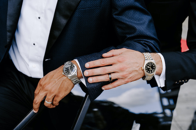 The grooms show of their luxury watches. 