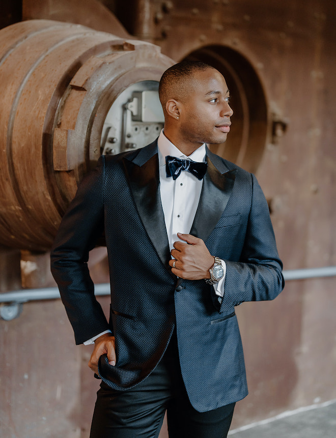 The groom poses in his tuxedo from b.Kreps&co at his wedding venue in Houston, Texas. 