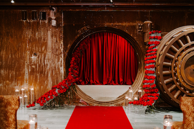 Red roses and candlelight decorating the Vault for a romantic wedding editorial.