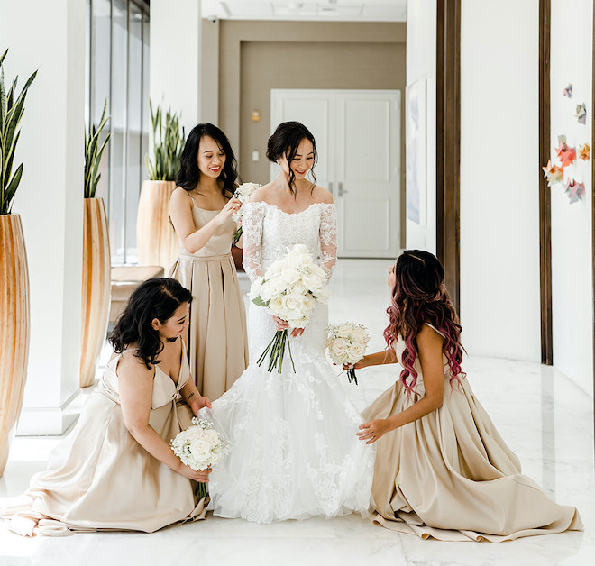 The bridesmaids helping the bride get ready.