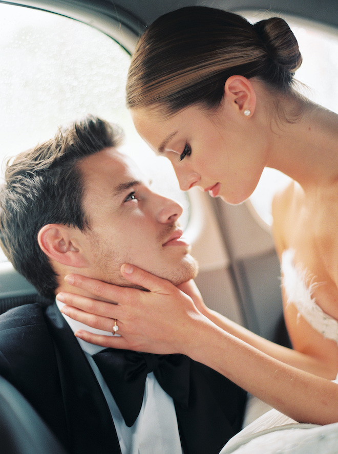 The bride and groom gazing at each other in a car during the Parisian love story by Sean Thomas Photography.