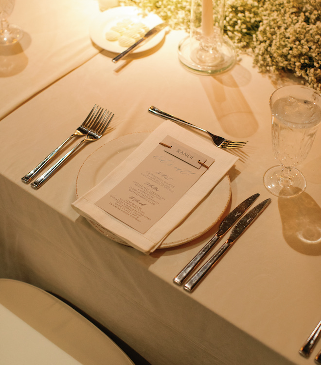 The table setting with personalized menus at a wedding in the San Antonio hill country.