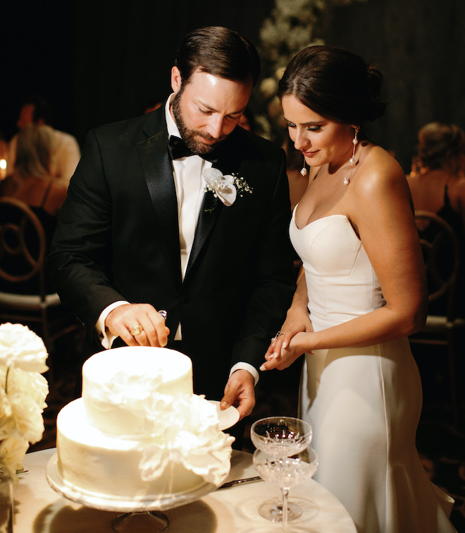 The bride and groom cutting their cake.