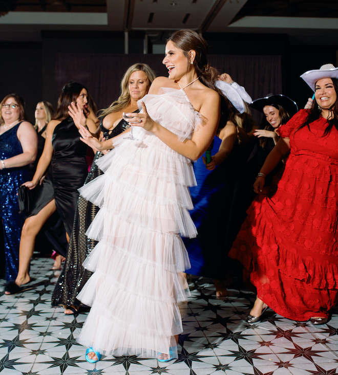 The bride dancing along with guests.