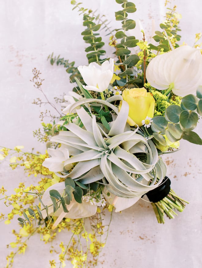A bouquet of greenery and yellow florals.