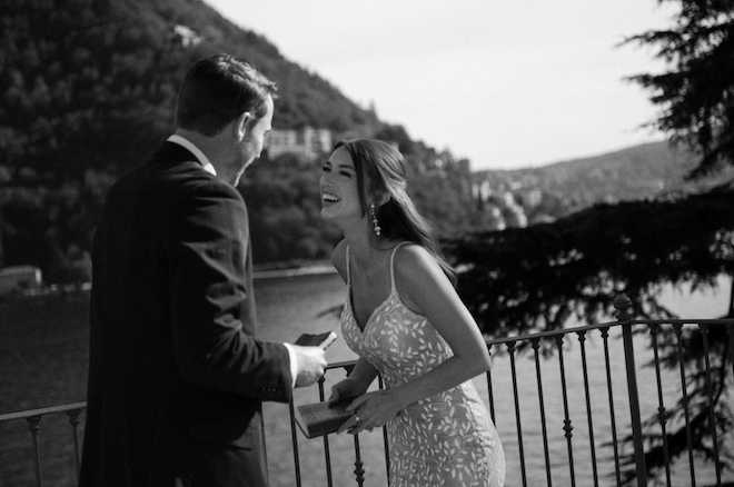 The bride and groom laughing while holding their vow journals.