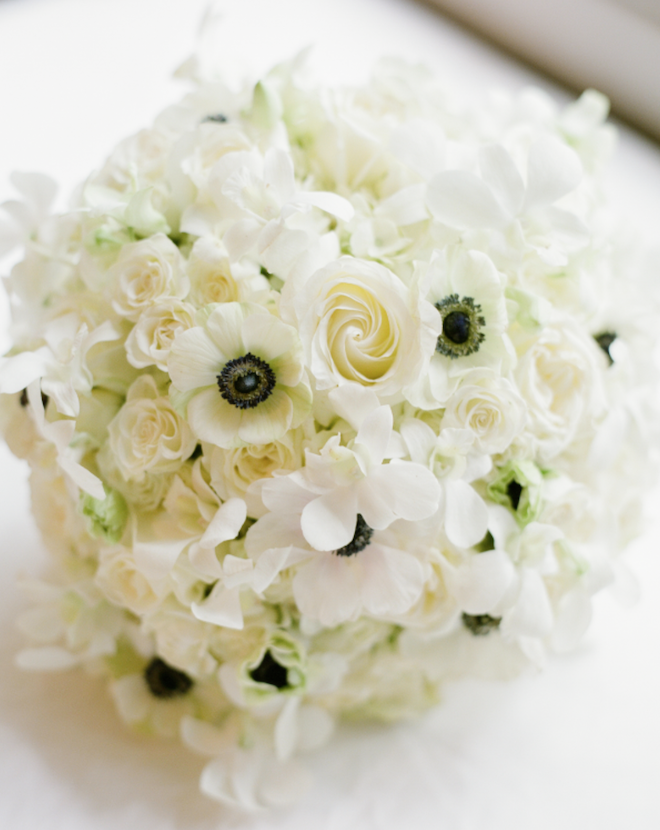 A bouquet with white roses and anemones. 