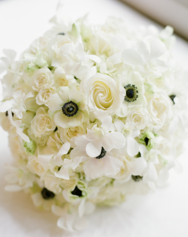 A bouquet with white roses and anemones.