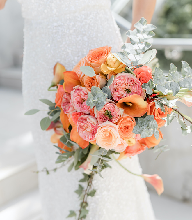 A pink and orange summer wedding bouquet.