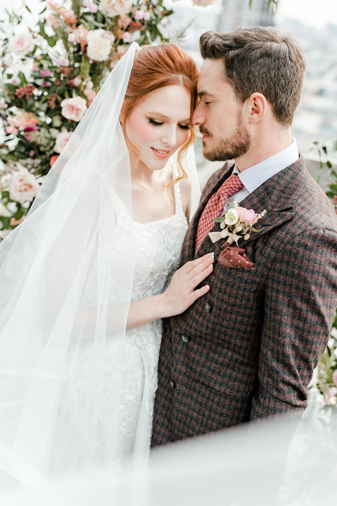 The groom resting his head on the bride during the ceremony photos of the light & airy wedding editorial.