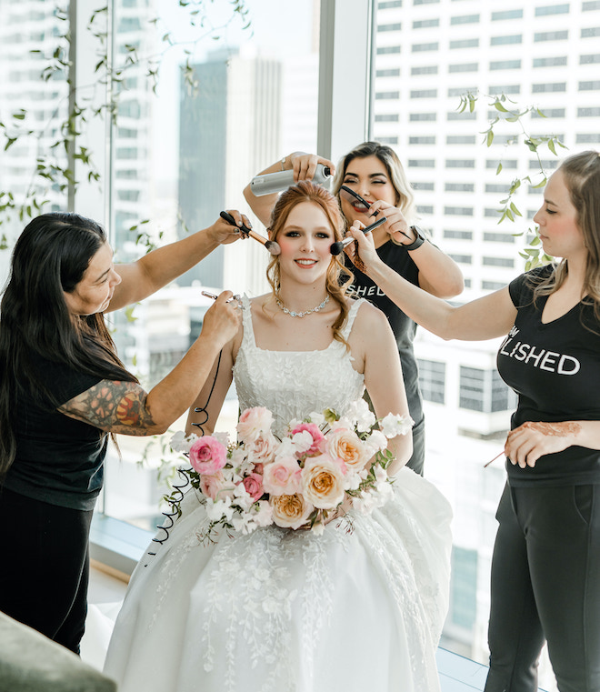 The bride getting her makeup done by Polished Makeup & Hair.