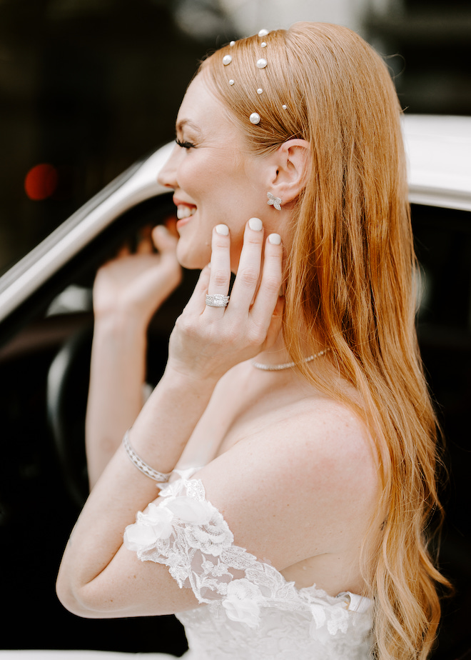 The bride's timeless soft glam bridal look with pearl accessories in her hair.