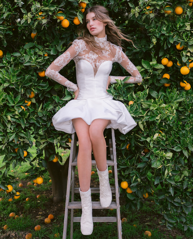 A white mini dress with lace sleeves by Monique Lhuillier.