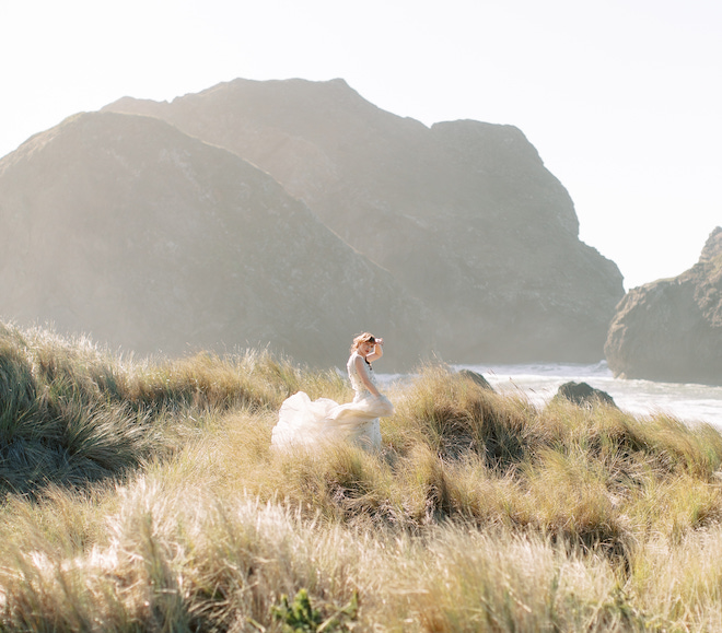 The bride posing in a field for bridal inspiration on the Oregon Coast.