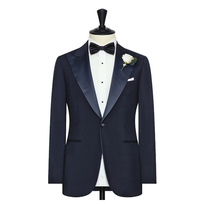 A navy blue custom tuxedo from b.Kreps&Co., a perfect look for the groom.