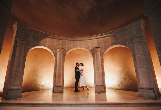 A couple hugging during their engagement photos at The Bell Tower on 34th.