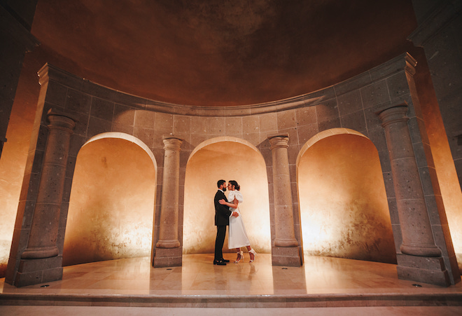 A couple hugging during their engagement photos at The Bell Tower on 34th.