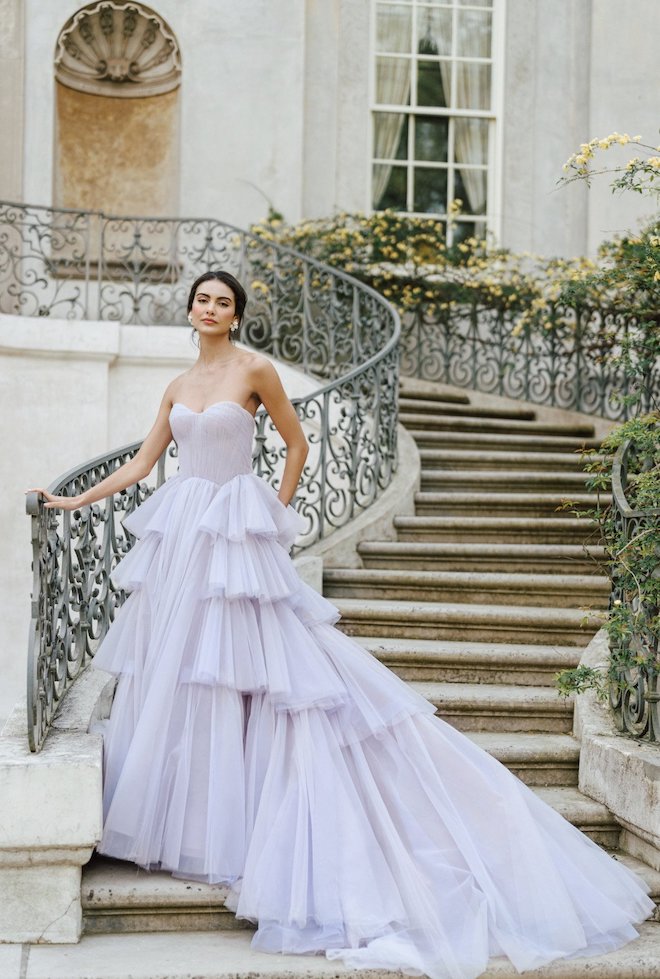 A pastel purple gown with tulle flowing into a train.