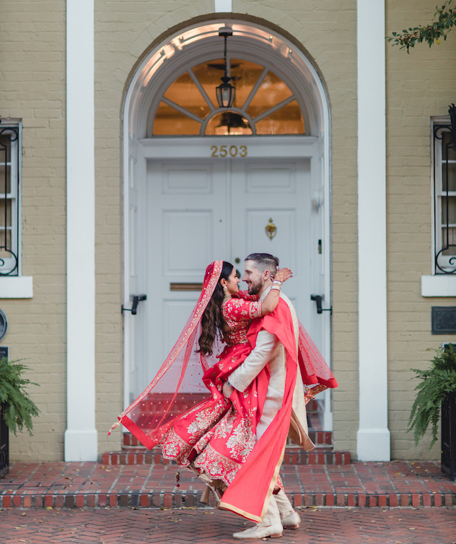 The bride jumping into the grooms arms.