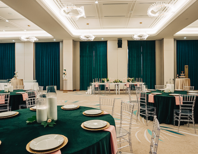 The Luna ballroom decorated with emerald green and pink linens.