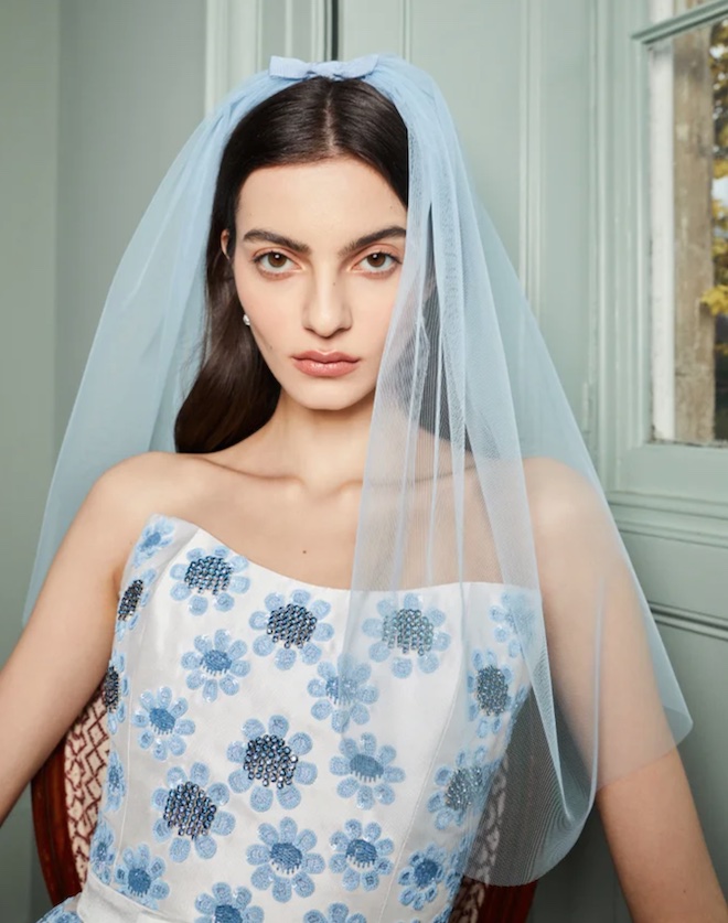 A white and blue mini dress with a short blue veil.