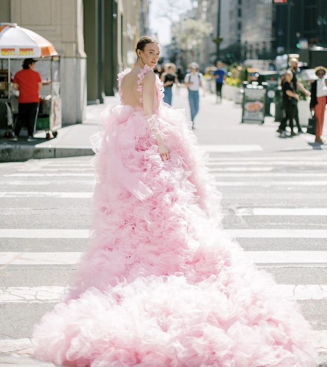 A non-white wedding gown with pink ruffles by Millia London.