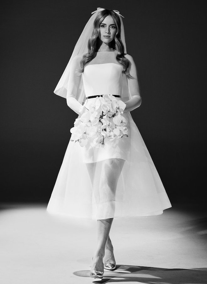 A mini dress with a tulle tea-length overskirt by Romona Keveza.
