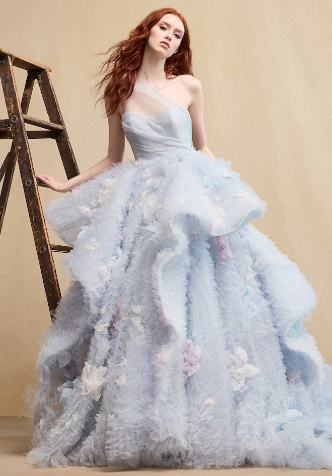 A model wearing a blue ruffle gown by Ines Di Santo