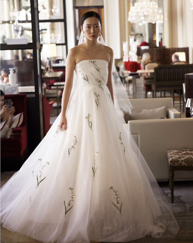 A tulle gown with green floral appliques by Sachin & Babi.