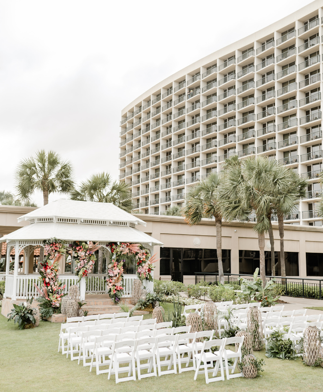A gulf-front gazebo decorated with flowers for a wedding ceremony at the San Luis Resort, Spa and Conference Center. 