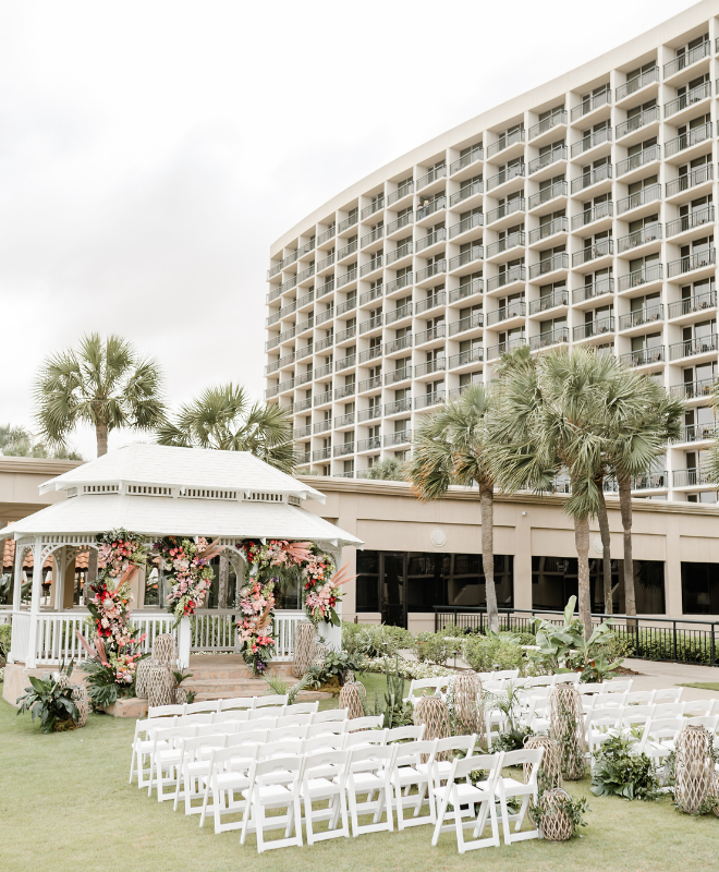 A gulf-front gazebo decorated with flowers for a wedding ceremony at the San Luis Resort, Spa and Conference Center.