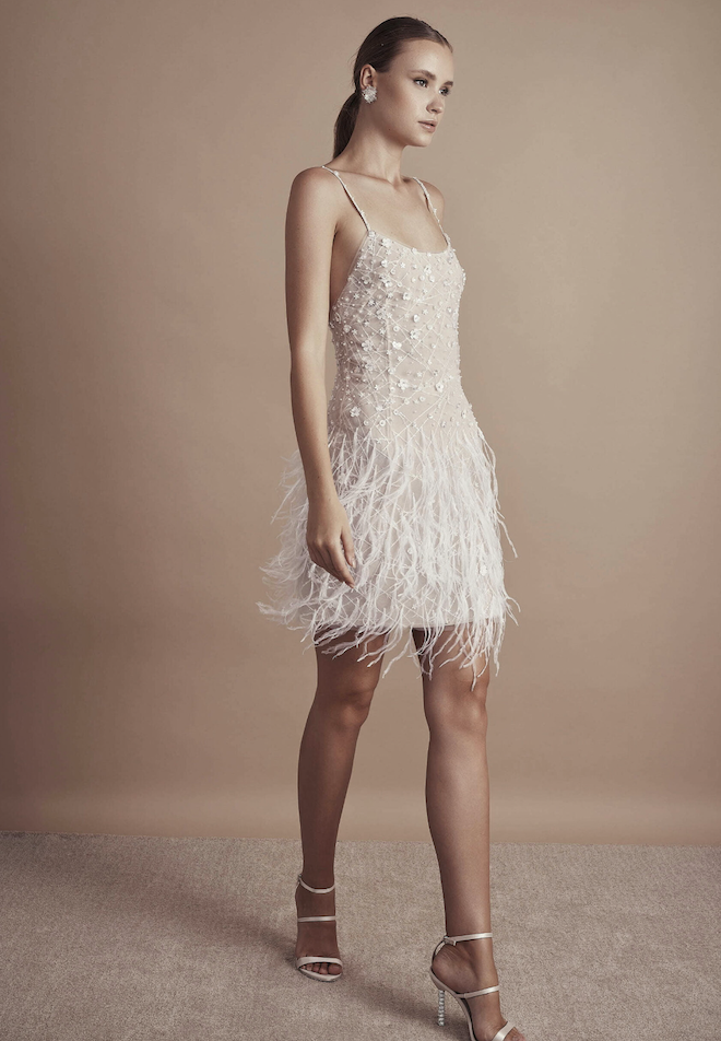 A spaghetti strap dress with feathers, pearls and beads.