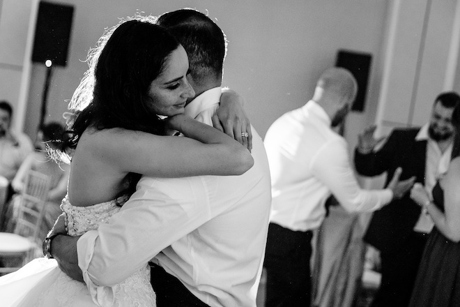 The bride and groom hugging on the dance floor. 