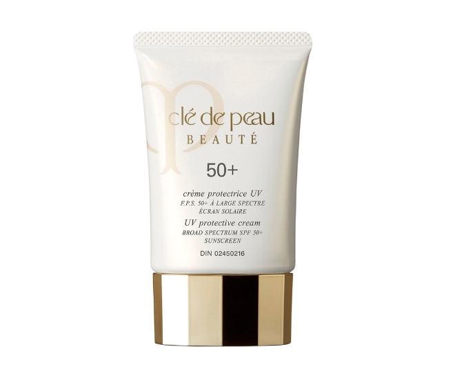 A cream bottle that reads "Cle de peau beaute 50+ UV protective cream broad spectrum SPF 50+ Sunscreen"